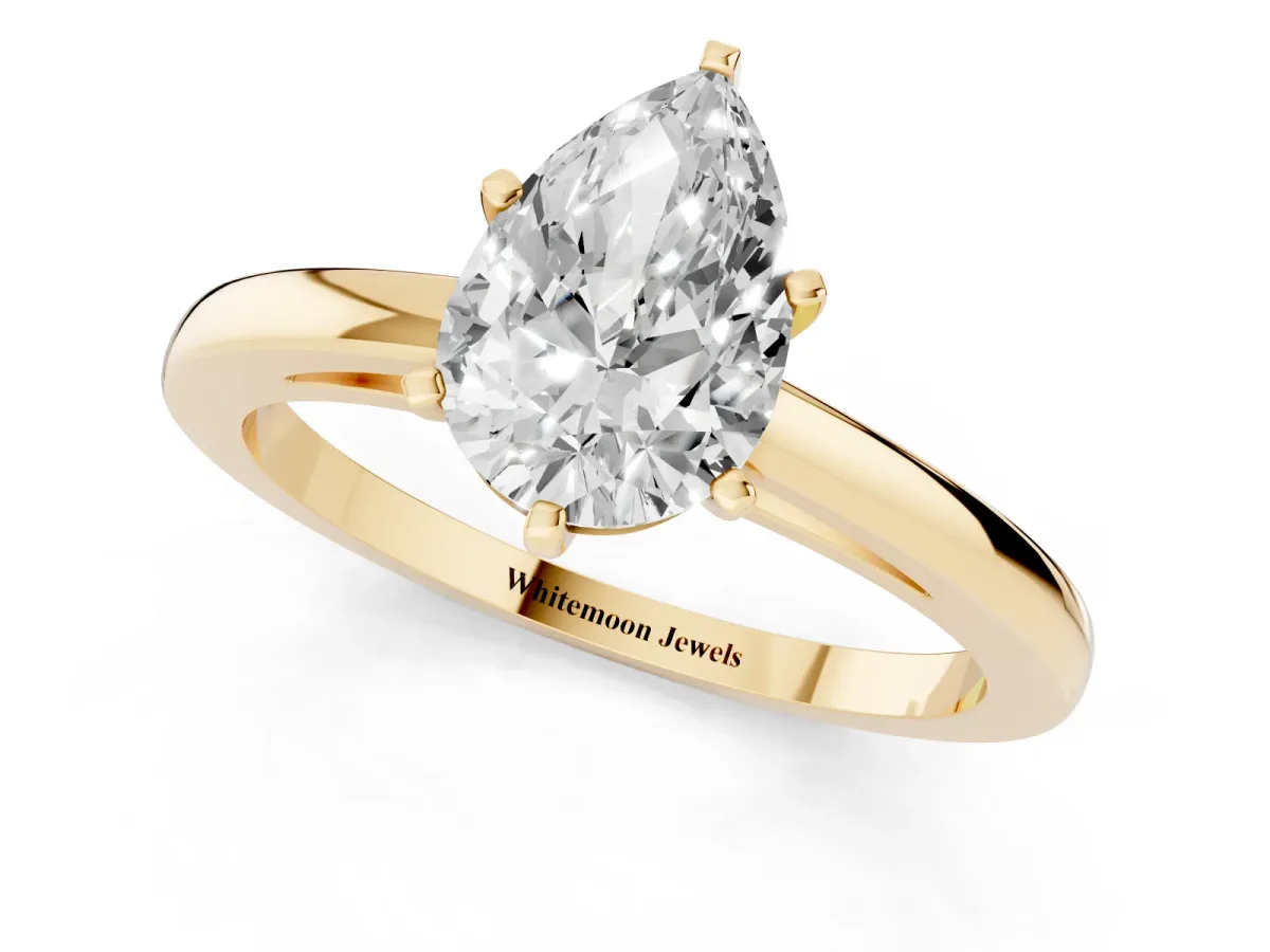 Pear Cut Solitaire Diamond Engagement Ring with Four-Prong Setting on a Classic Band Yellow gold
