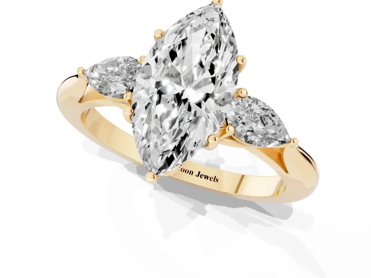 Three-Stone Marquise Cut Diamond Ring with Pear Side Stones in Four-Prong Setting Yellow gold