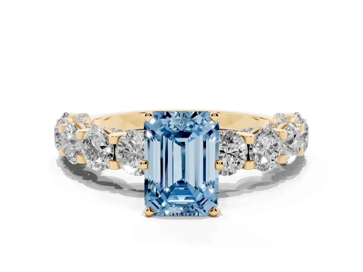 Fancy Blue Emerald Cut Diamond Side Stone Engagement Ring with Four-Prong Setting Yellow gold