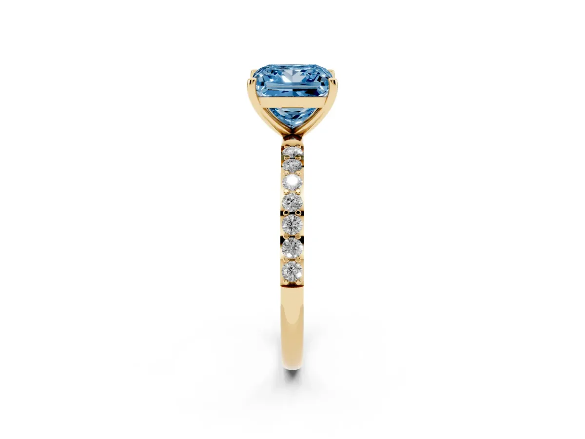 Fancy Blue Princess Cut Diamond Solitaire Ring with Round Pavé Shoulders and Prong Setting Yellow gold