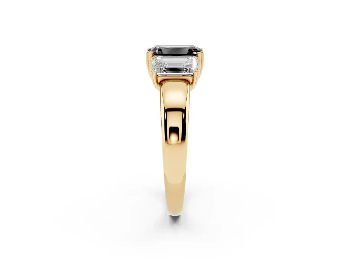 Fancy Black Three-Stone Emerald Cut Cut Diamond Ring with Channel Set Band and Four-Prong Setting Yellow gold