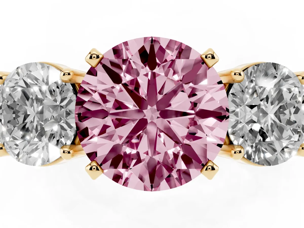 Fancy Pink Three-Stone Round Cut Diamond Ring with Round Side Stones, Classic Band, and Four-Prong Setting Yellow gold