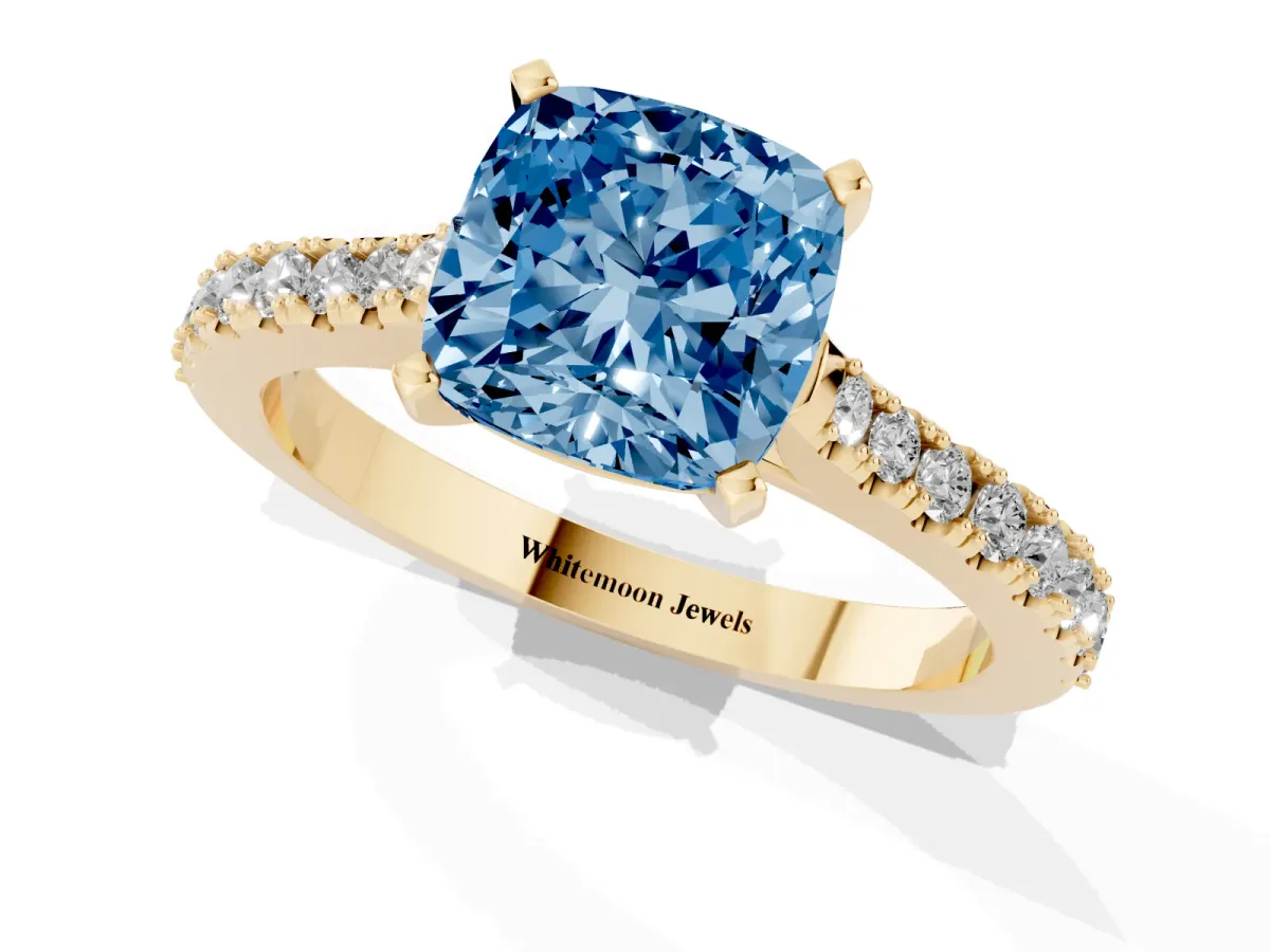 Fancy Blue Cushion Cut Cut Solitaire Diamond Engagement Ring with Pave Band and Four-Prong Setting Yellow gold