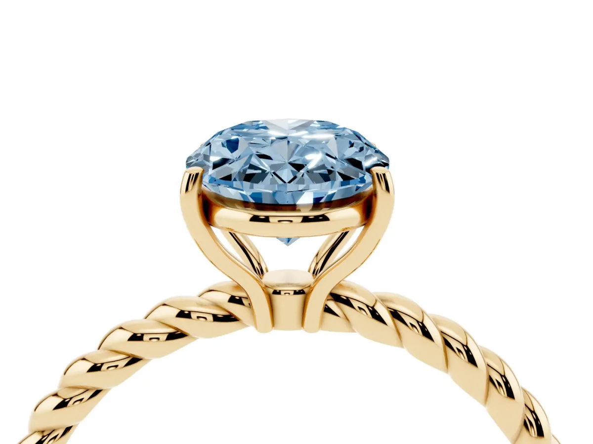 Fancy Blue Oval Cut Solitaire Twist Band Ring with Four-Prong Setting Yellow gold