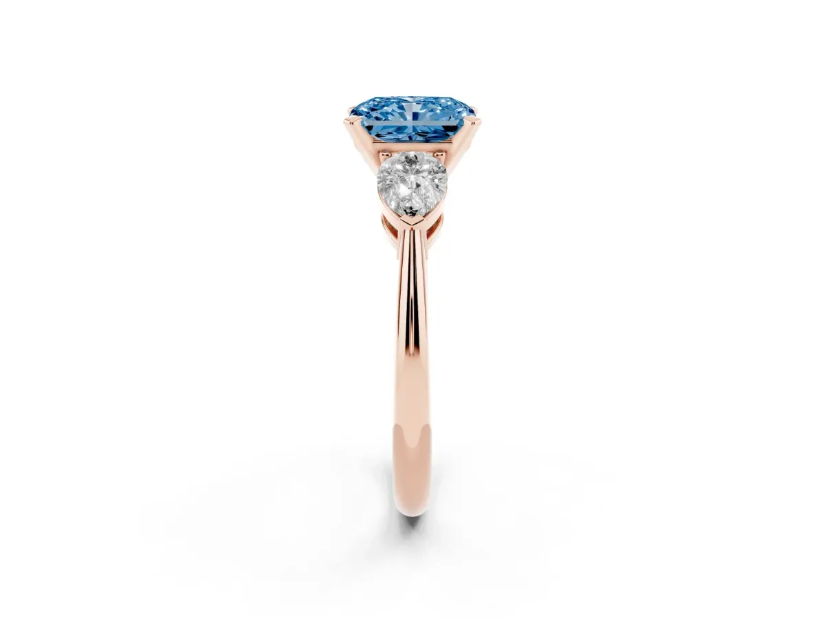 Fancy Blue Three-Stone Radiant Cut Diamond Ring with Pear Side Stones and Four-Prong Setting Rose gold