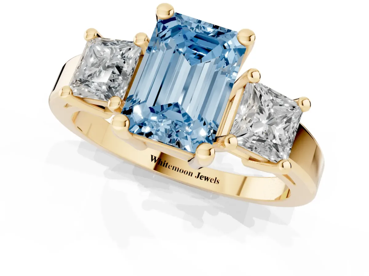 Fancy Blue Three-Stone Emerald Cut Cut Solitaire Ring with Prong Setting Yellow gold