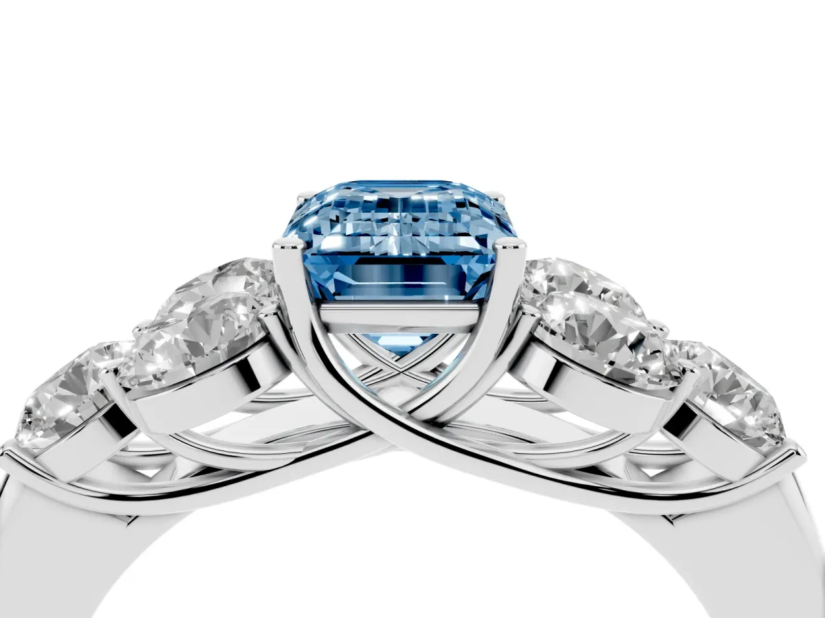 Fancy Blue Emerald Cut Cut Diamond Cluster Ring with Round Accent Stones and Prong Setting on a Classic Band White gold