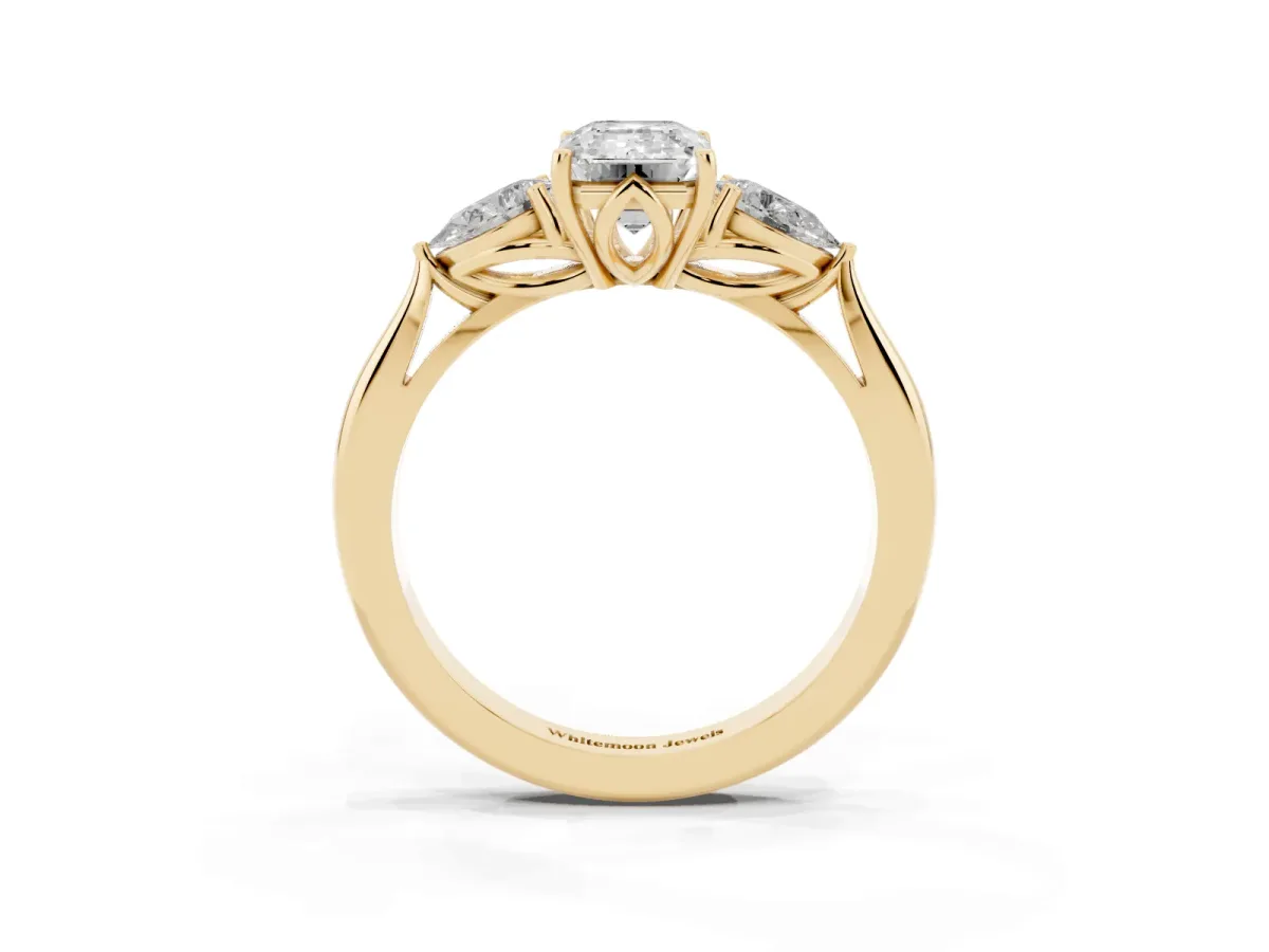 Emerald Cut Diamond Three-Stone Ring with Pear Side Stones and Prong Setting Yellow gold