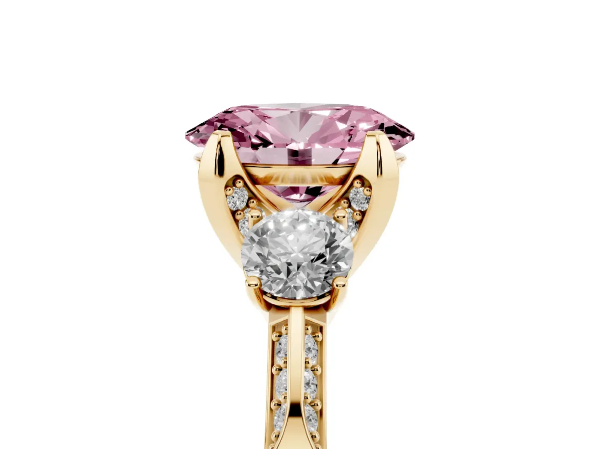 Fancy Pink Oval Cut Brilliant Three-Stone Diamond Ring with Pavé Band and Four-Prong Setting Yellow gold