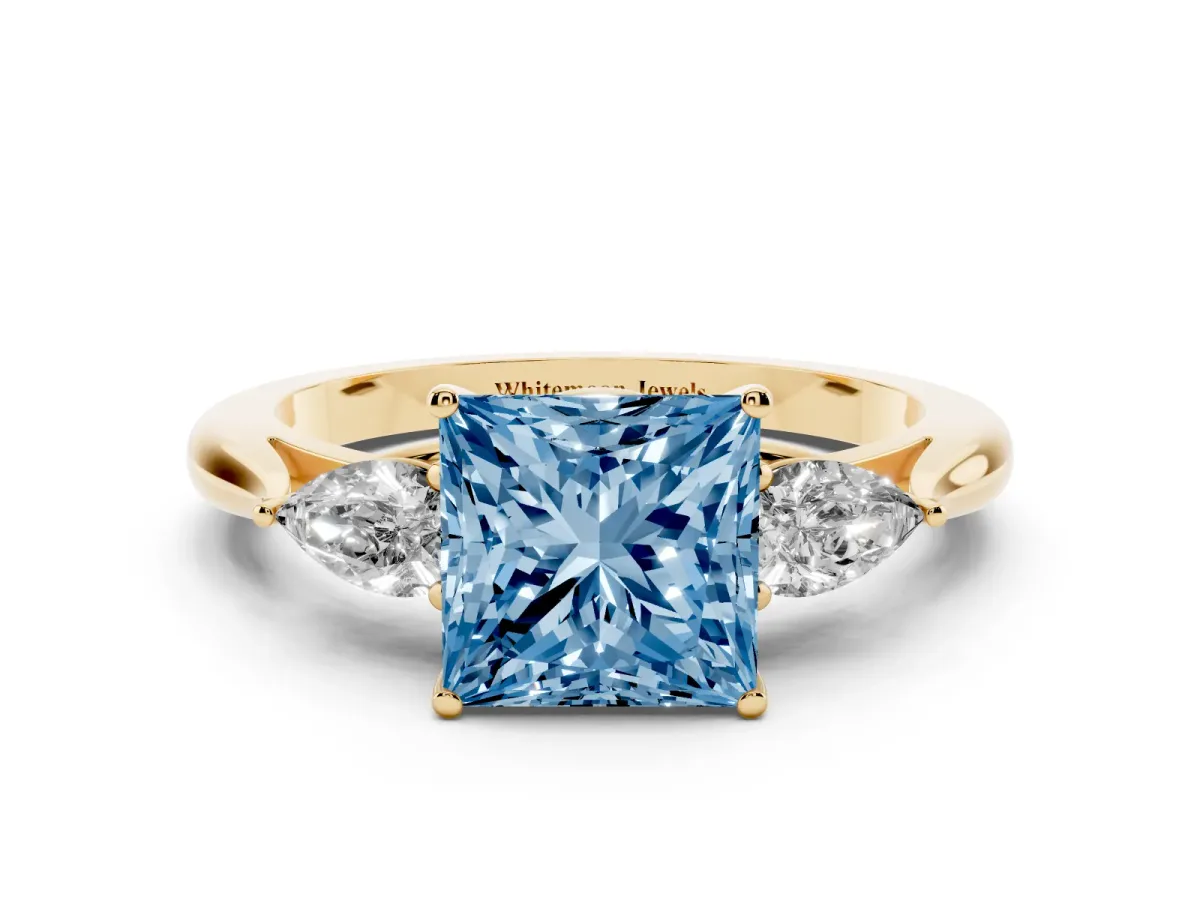Fancy Blue Three-Stone Princess Cut Brilliant Diamond Solitaire Ring with Tapered Band and Four-Prong Setting Yellow gold