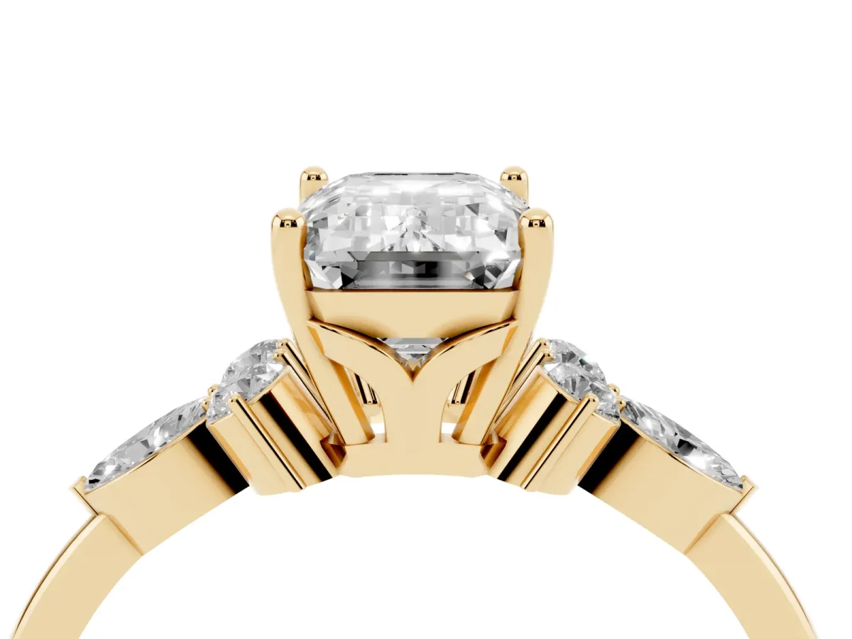 Emerald Cut Brilliant Diamond Solitaire Ring with Pear Side Stones and Four-Prong Setting Yellow gold