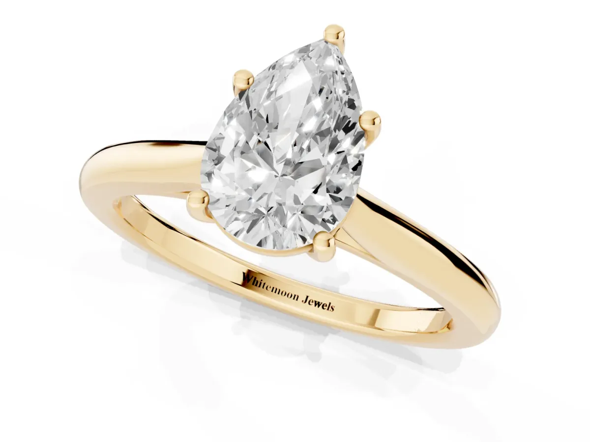 Pear Cut Cut Solitaire Ring with Cathedral Band and Four-Prong Setting Yellow gold