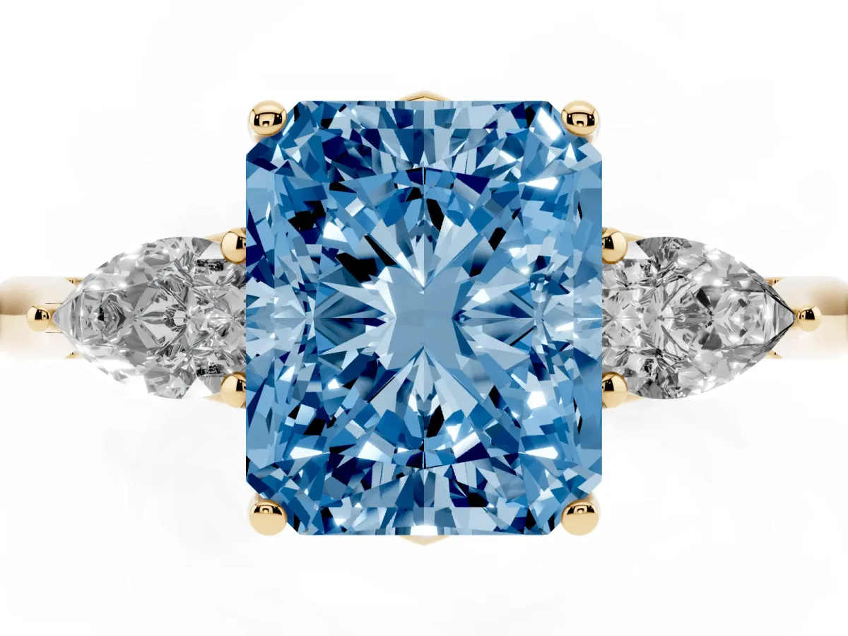 Fancy Blue Three-Stone Radiant Cut Brilliant Diamond Solitaire Ring with Tapered Band and Four-Prong Setting Yellow gold