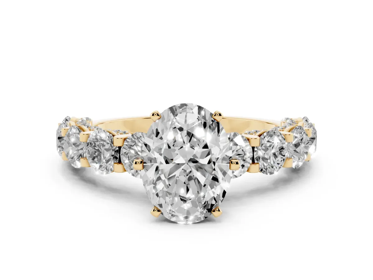 Oval Cut Diamond Side Stone Engagement Ring with Four-Prong Setting Yellow gold
