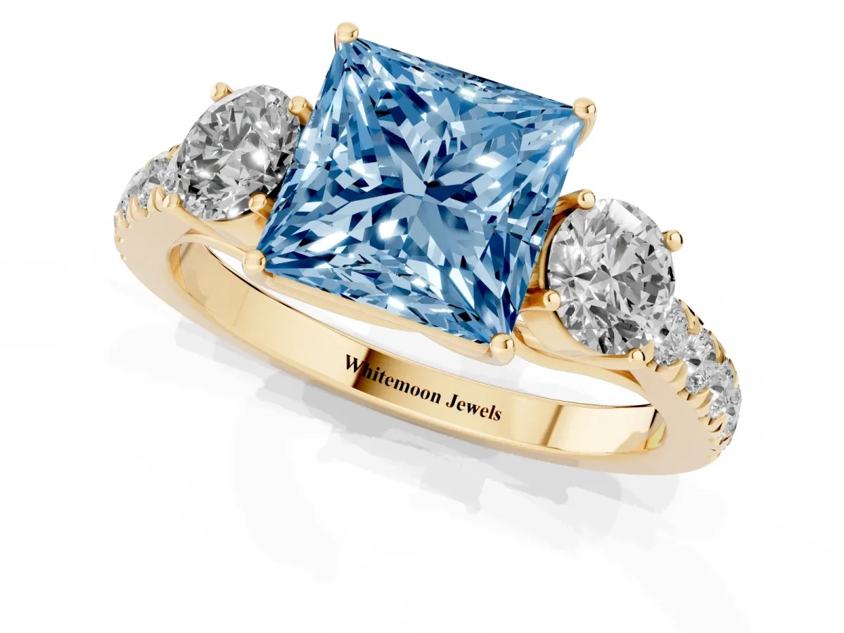 Fancy Blue Princess Cut Cut Diamond Three-Stone Ring with Round Side Stones and Pavé Band Yellow gold