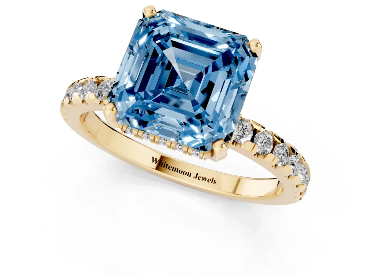 Fancy Blue Asscher Cut Diamond Solitaire Ring with Round Pavé Band and Four-Prong Setting Yellow gold