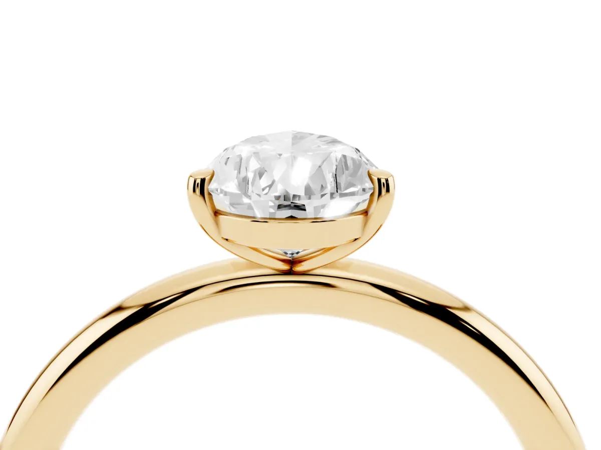 Pear Cut Solitaire Diamond Ring with Four-Prong Setting on a Plain Band Yellow gold