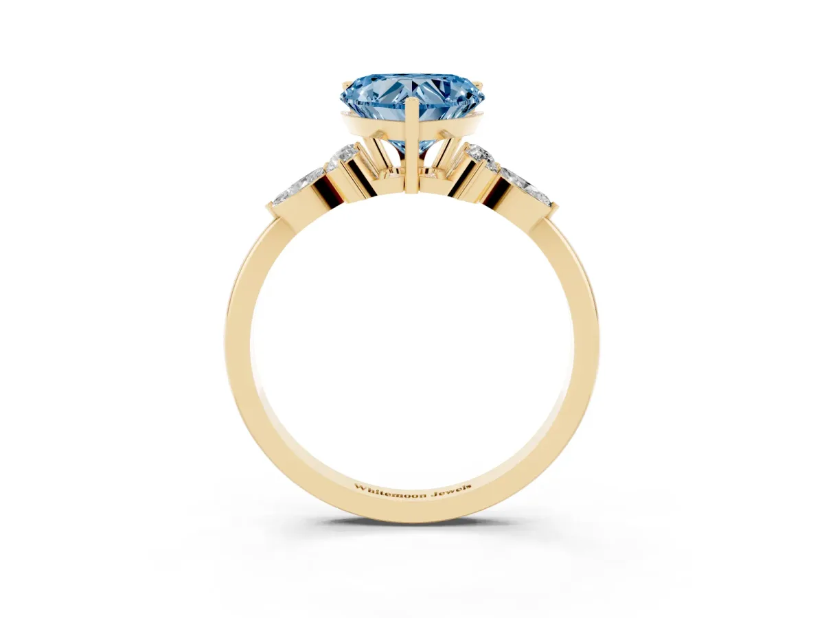 Fancy Blue Heart Cut Brilliant Diamond Solitaire Ring with Pear Side Stones and Four-Prong Setting Yellow gold
