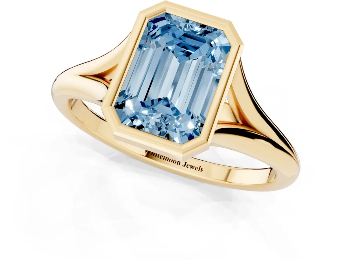 Fancy Blue Bezel Set Emerald Cut Cut Solitaire Ring with Tapered Band Yellow gold
