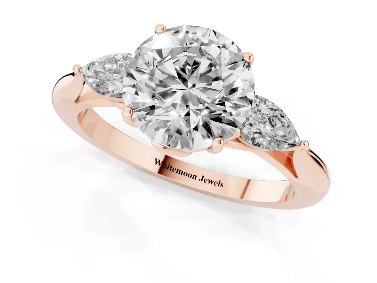 Round Cut Diamond Three-Stone Ring with Pear Side Stones and Prong Setting Rose gold