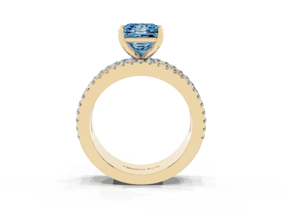 Fancy Blue Princess Cut Diamond Solitaire Ring with Pavé and Channel Set Band Yellow gold