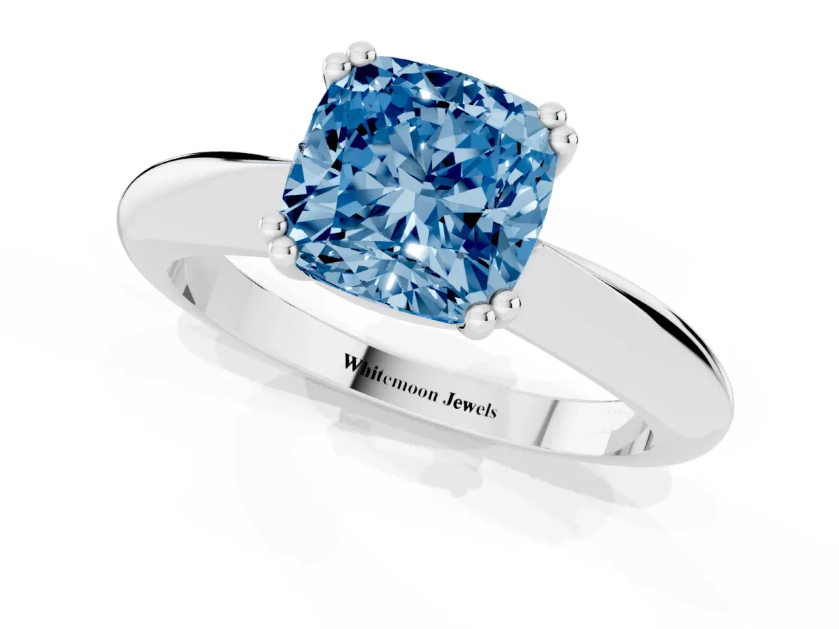 Fancy Blue Cushion Cut Cut Solitaire Engagement Ring with Tapered Band and Four-Prong Setting Platinum