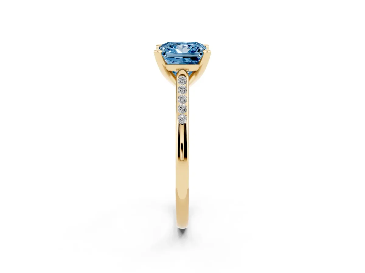 Fancy Blue Princess Cut Diamond Solitaire Ring with Channel Set Round Band and Prong Setting Yellow gold