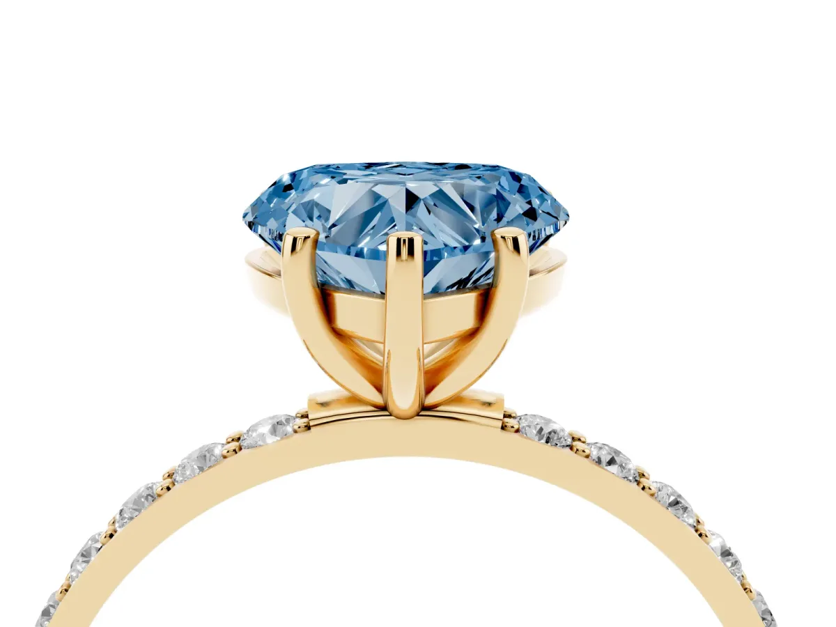 Fancy Blue Heart Cut Diamond Solitaire Ring with Round Pavé Shoulders and Prong Setting Yellow gold