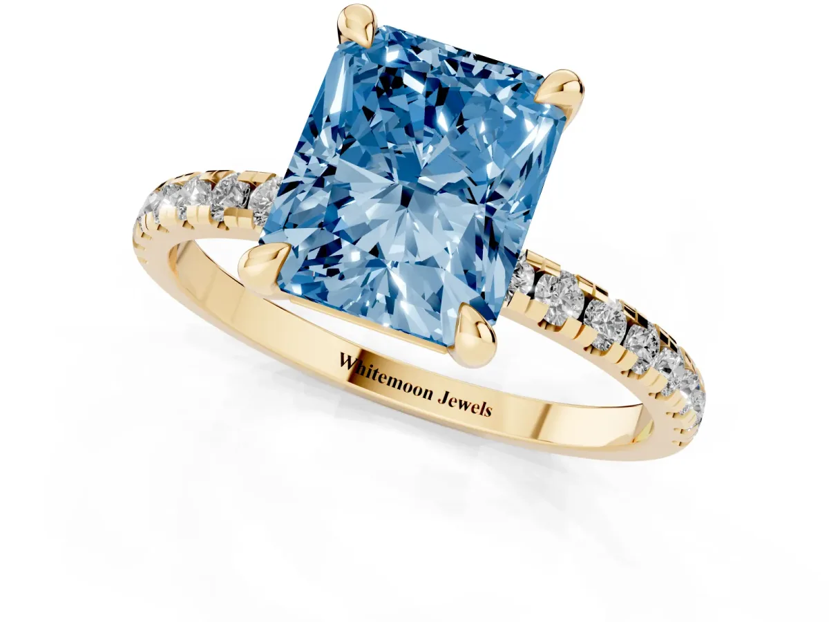 Fancy Blue Radiant Cut Diamond Brilliant Solitaire Ring with Pavé Band and Four-Prong Setting Yellow gold