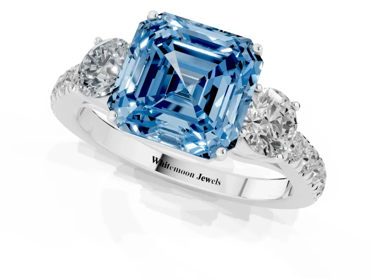 Fancy Blue Asscher Cut Cut Diamond Three-Stone Ring with Round Side Stones and Pavé Band White gold