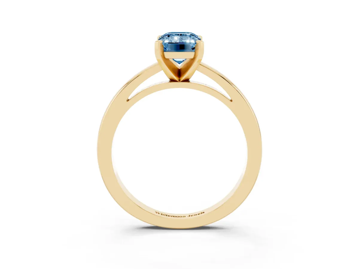 Fancy Blue Emerald Cut Solitaire Diamond Engagement Ring with Four-Prong Setting on a Classic Band Yellow gold