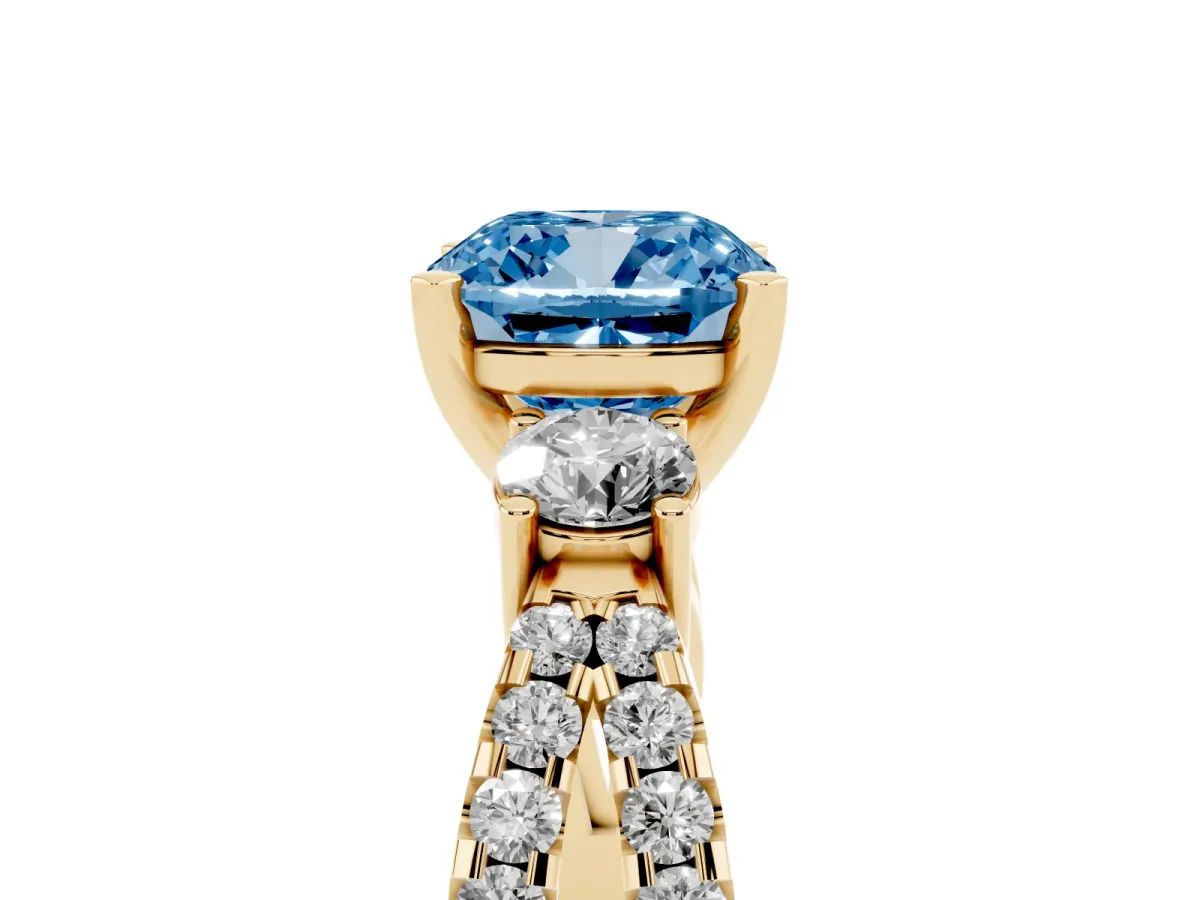 Fancy Blue Cushion Cut Diamond Three-Stone Ring with Pavé Split Shank and Four-Prong Setting Yellow gold