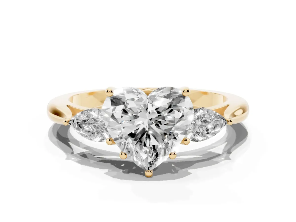 Three-Stone Heart Cut Brilliant Diamond Solitaire Ring with Tapered Band and Four-Prong Setting Yellow gold