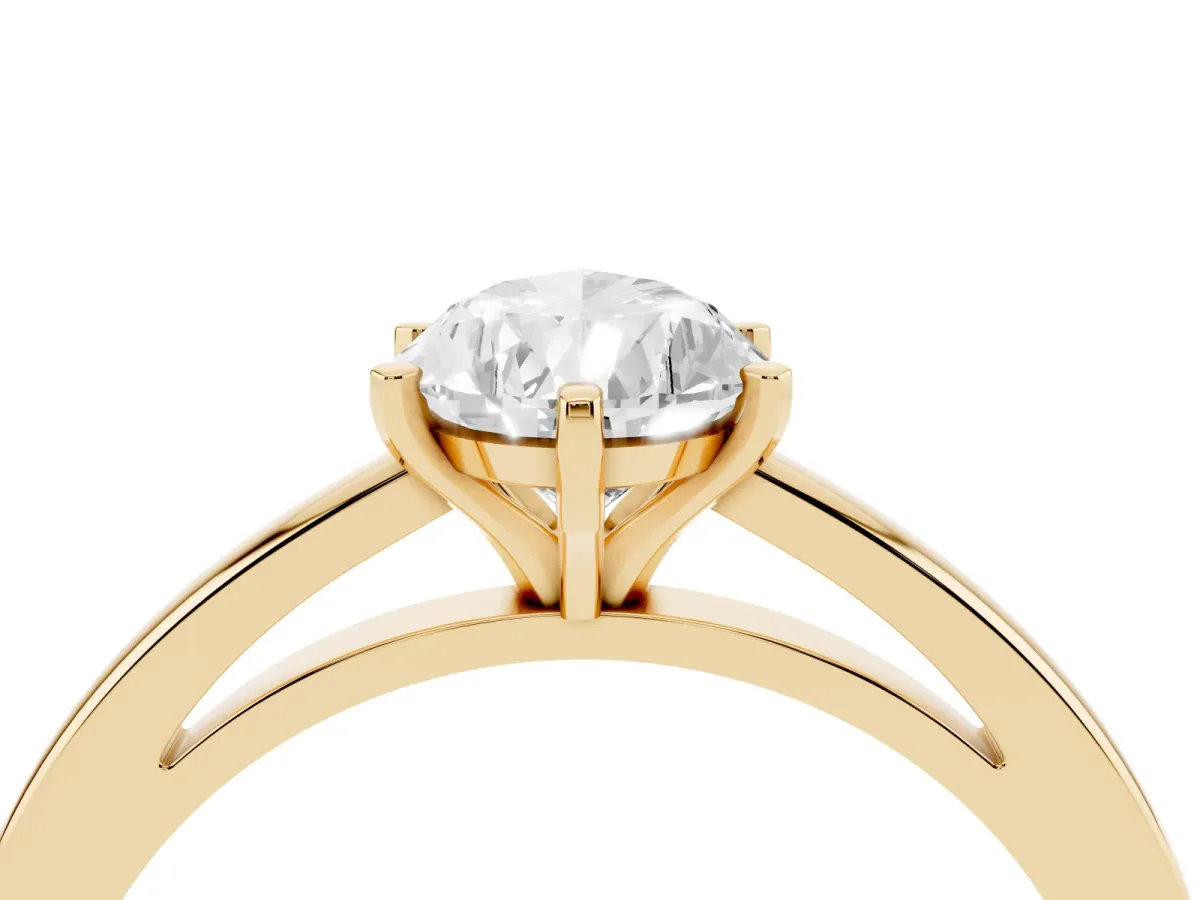 Pear Cut Solitaire Diamond Engagement Ring with Four-Prong Setting on a Classic Band Yellow gold
