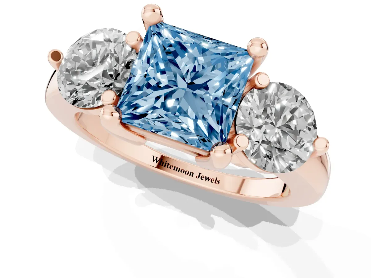 Fancy Blue Three-Stone Princess Cut Brilliant Cut Solitaire Ring with Prong Setting on a Classic Band Rose gold