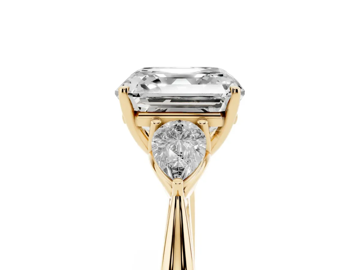 Three-Stone Asscher Cut Diamond Ring with Pear Side Stones in Four-Prong Setting Yellow gold