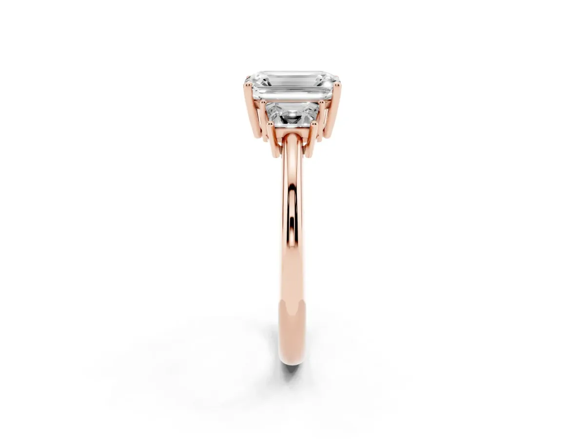 Emerald Cut Diamond Three-Stone Ring with Trapezoid Side Stones and Prong Setting Rose gold