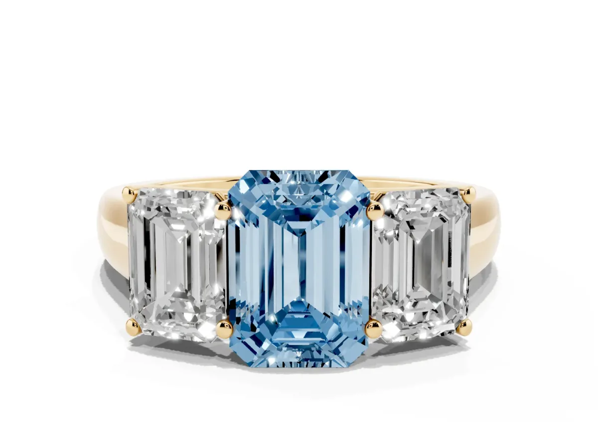 Fancy Blue Emerald Cut Three-Stone Diamond Ring with Prong Setting on a Classic Band Yellow gold