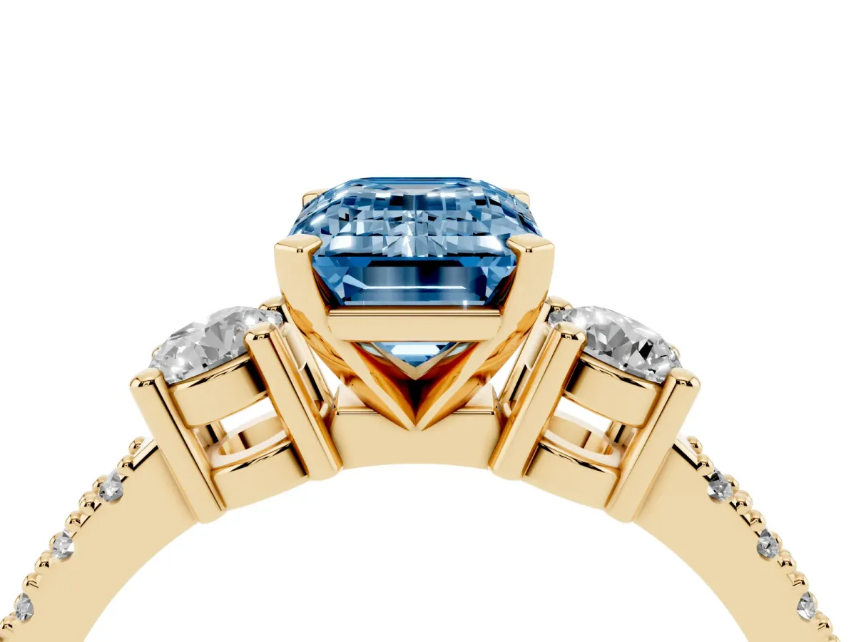 Fancy Blue Emerald Cut Three-Stone Diamond Pavé Band with Prong Setting Yellow gold