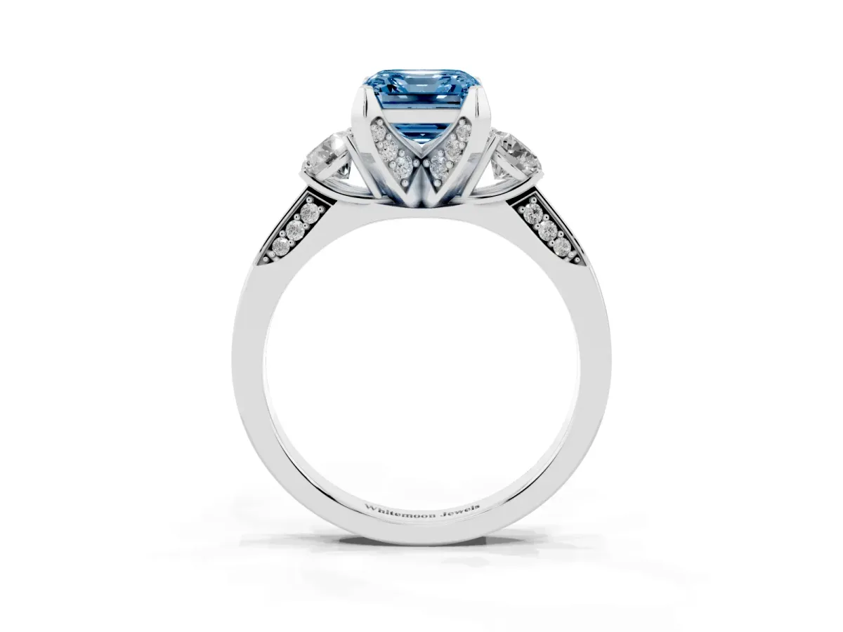 Fancy Blue Asscher Cut Brilliant Three-Stone Diamond Ring with Pavé Band and Four-Prong Setting White gold