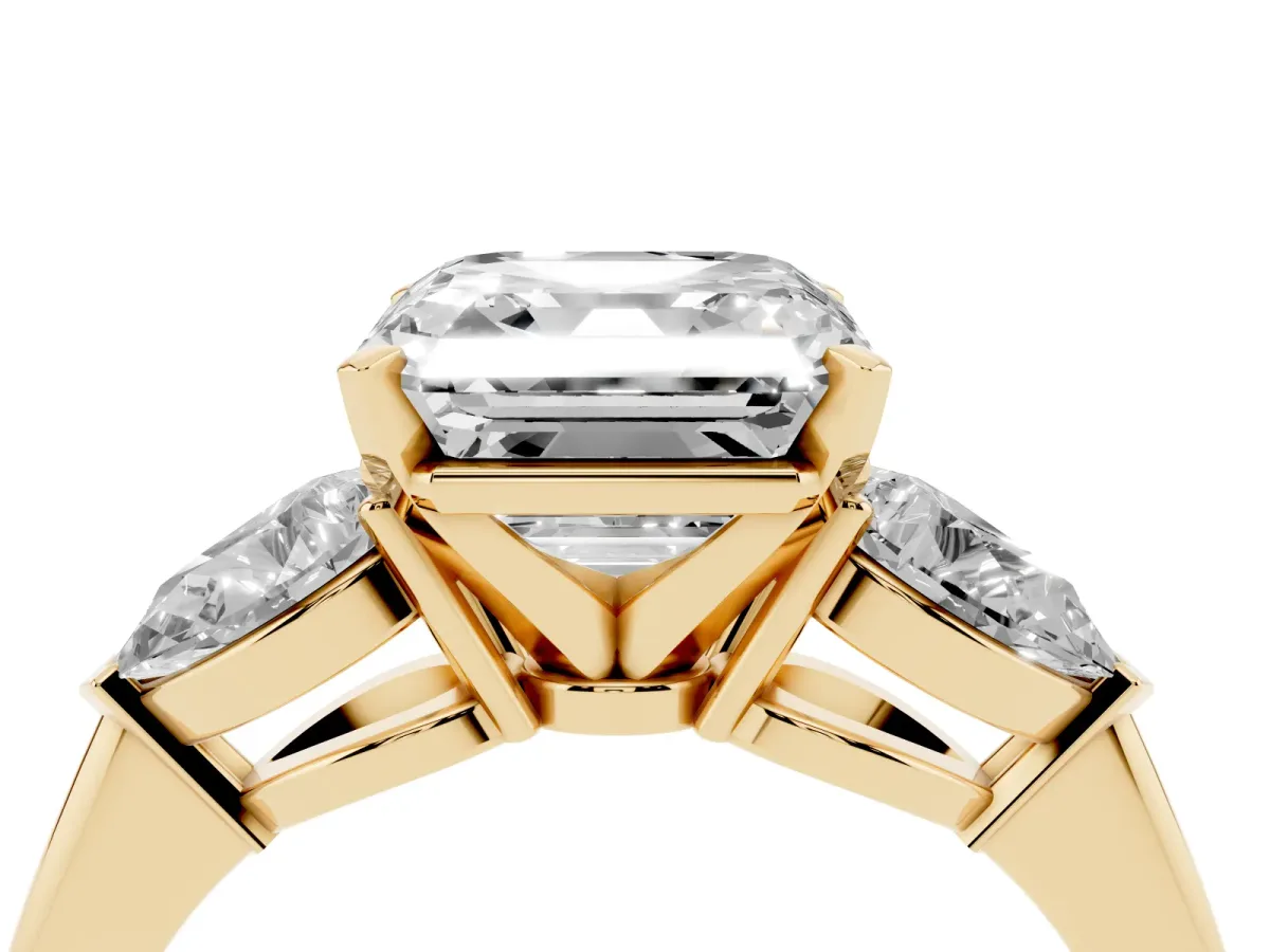 Three-Stone Asscher Cut Diamond Ring with Pear Side Stones and Four-Prong Setting Yellow gold