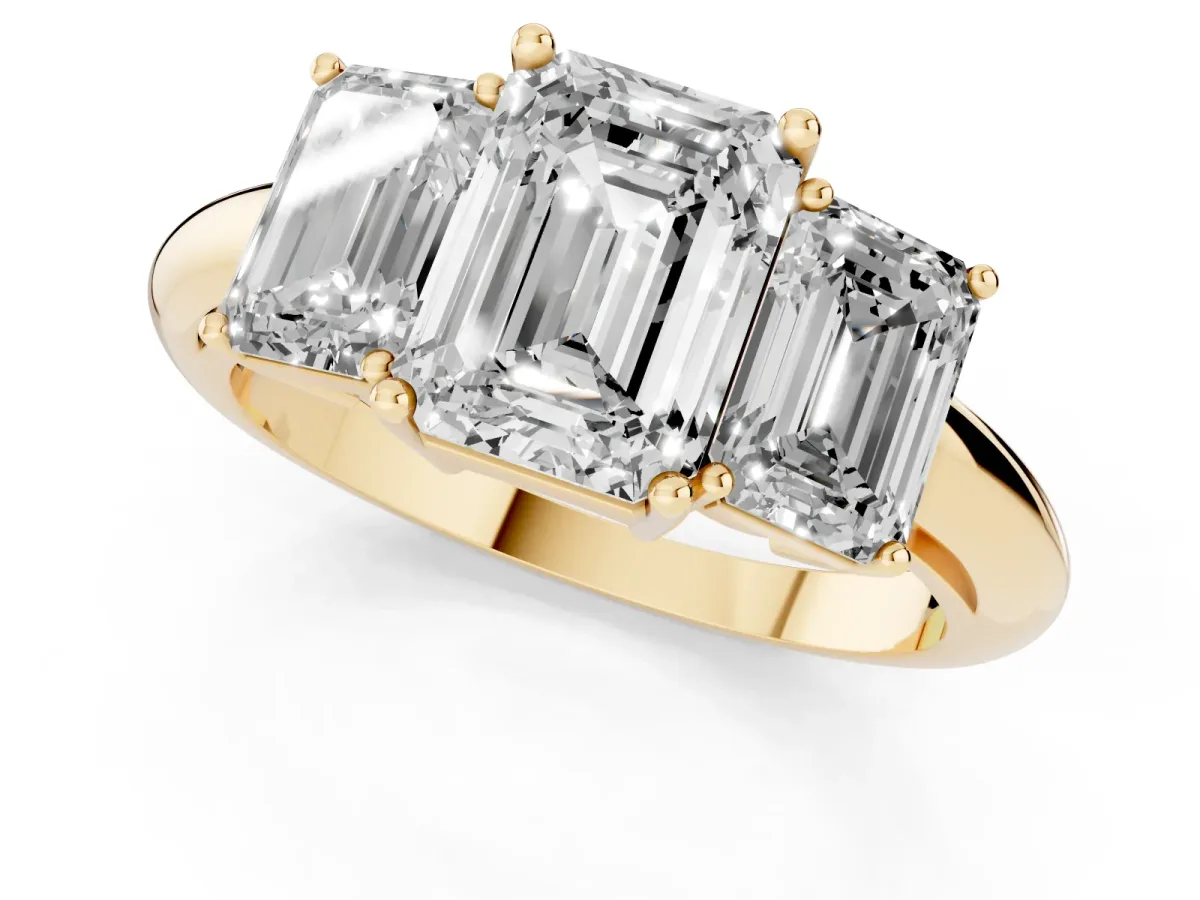 Three-Stone Emerald Cut Cut Diamond Engagement Ring with Prong Setting on a White Gold Band Yellow gold
