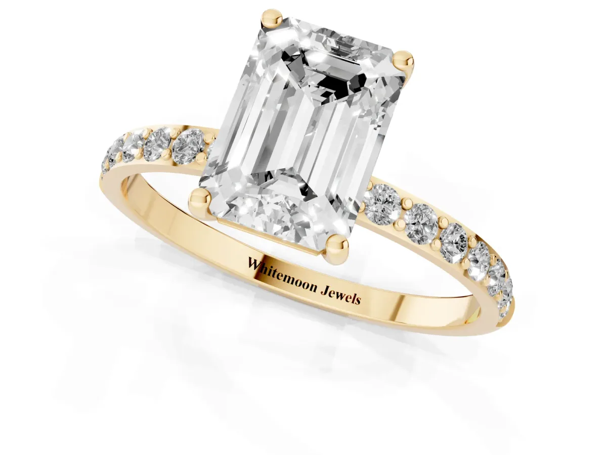 Emerald Cut Diamond Solitaire Ring with Round Pavé Shoulders and Prong Setting Yellow gold
