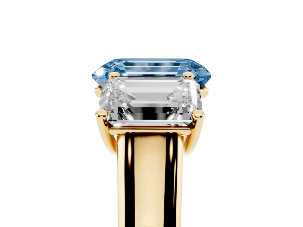 Fancy Blue Emerald Cut Three-Stone Diamond Ring with Prong Setting on a Classic Band Yellow gold