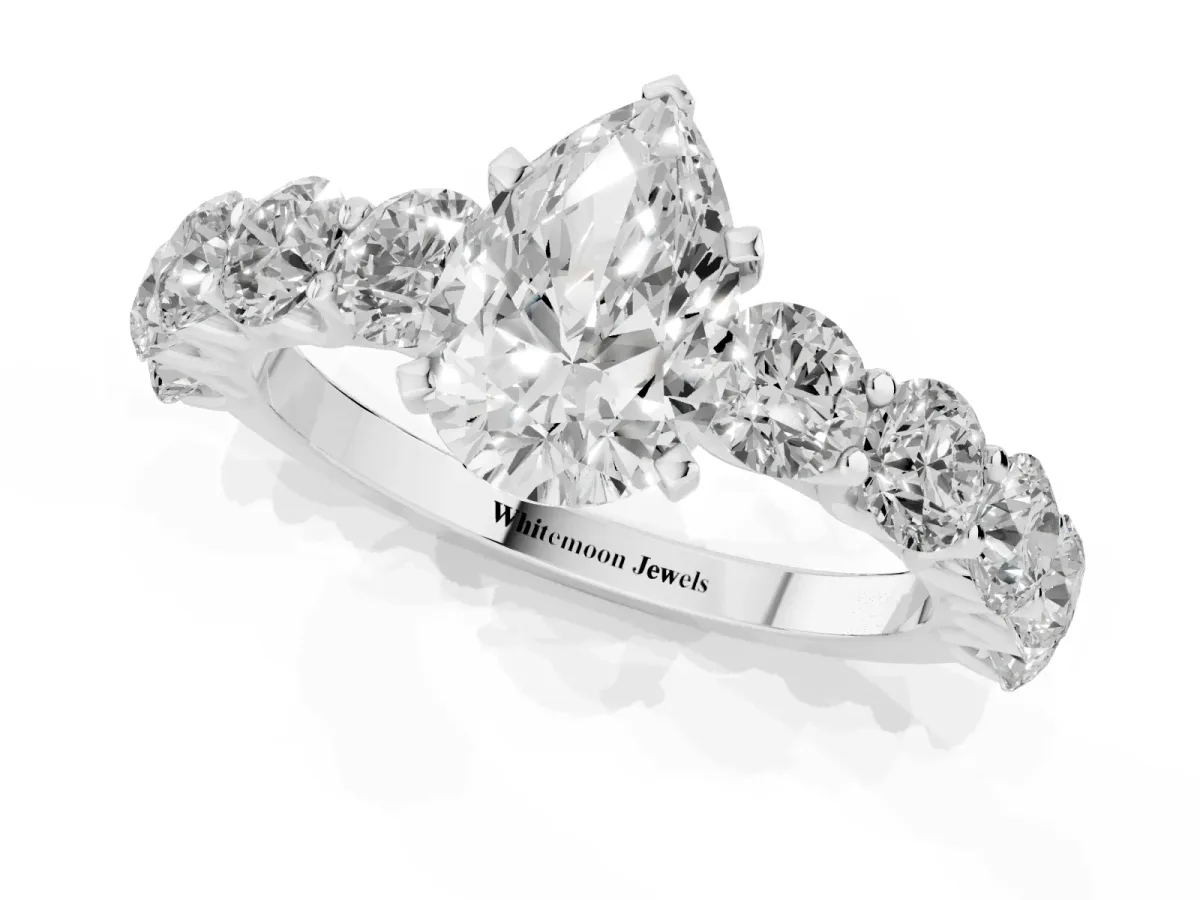 Pear Cut Diamond Prong Setting with Side Stones on a Pave Band Silver