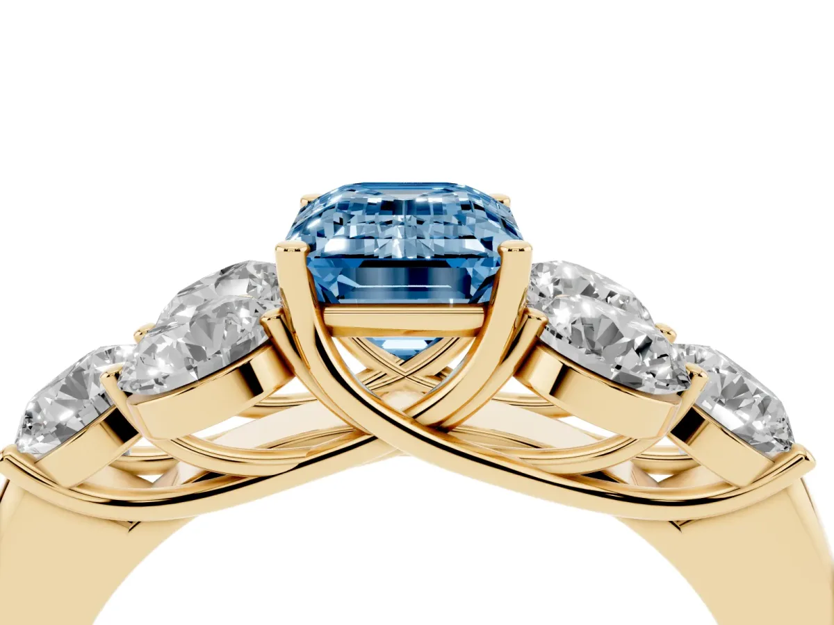 Fancy Blue Emerald Cut Cut Diamond Cluster Ring with Round Accent Stones and Prong Setting on a Classic Band Yellow gold