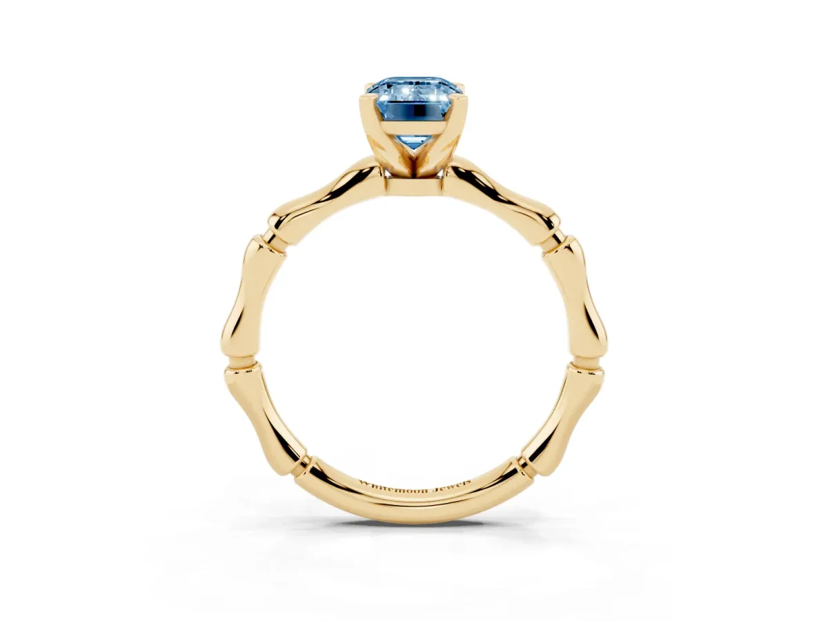 Fancy Blue Emerald Cut Solitaire Diamond Ring with Bamboo Band and Four-Prong Setting Yellow gold