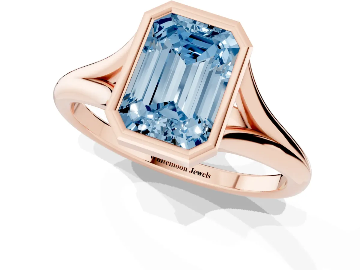Fancy Blue Bezel Set Emerald Cut Cut Solitaire Ring with Tapered Band Rose gold