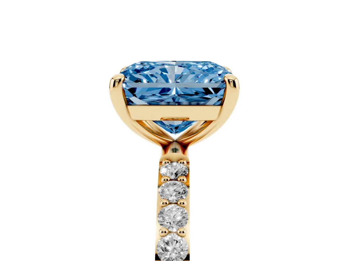 Fancy Blue Radiant Cut Diamond Solitaire Ring with Round Pavé Band and Prong Setting Yellow gold