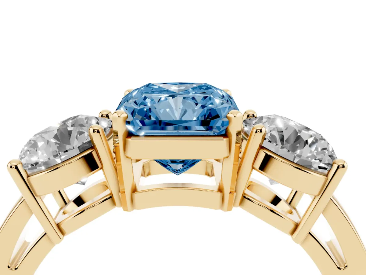 Fancy Blue Three-Stone Radiant Cut Diamond Ring with Round Side Stones, Classic Band, and Four-Prong Setting Yellow gold